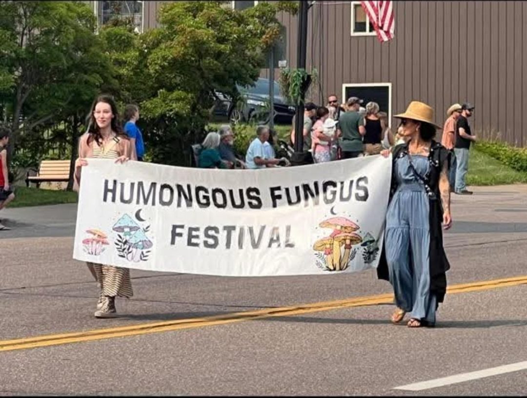 Fungus Fest image of 2 woman holding a banner