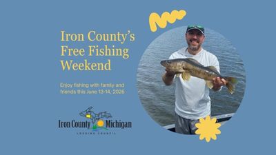 Man holding a fish on the lake during Michigan’s Summer Free Fishing Weekend