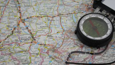 overhead shot of a map and compass