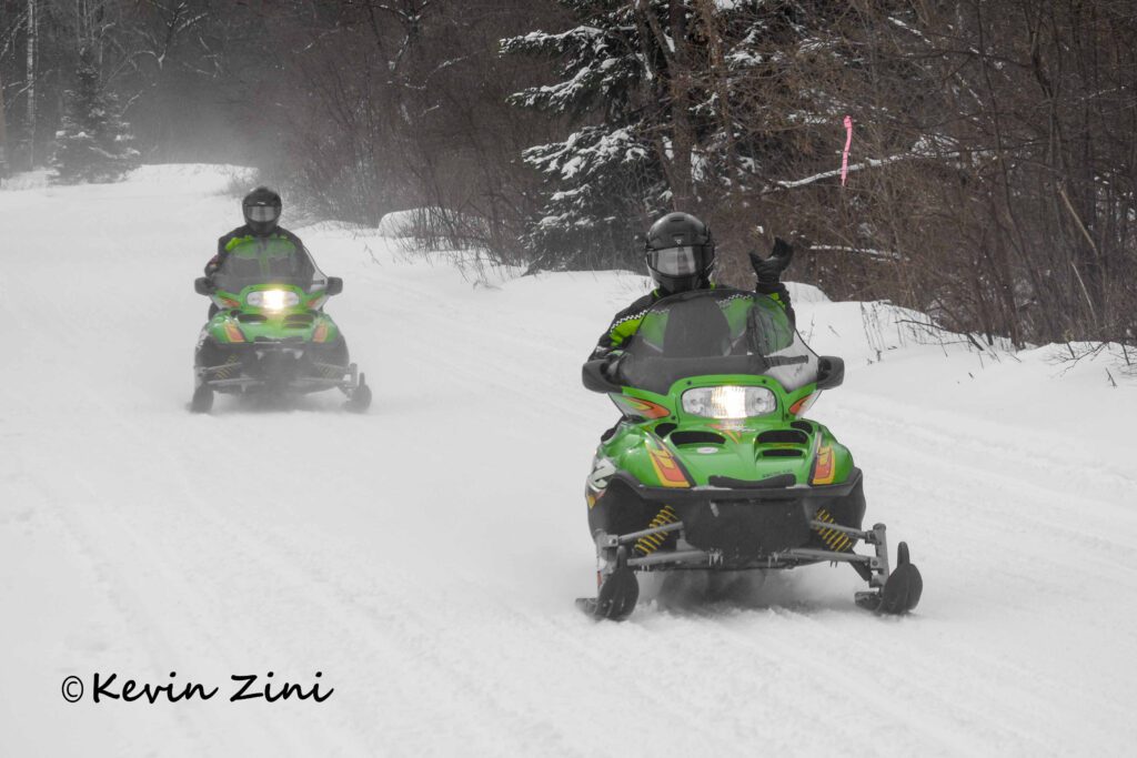 Snowmobiles on groomed trails in Iron County, Michigan.