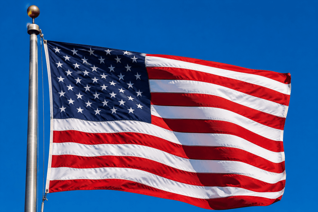 American Flag waving in the blue skies