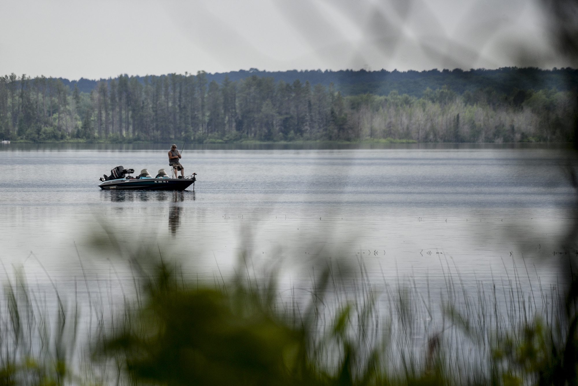 Man fishing in a boat ins summer