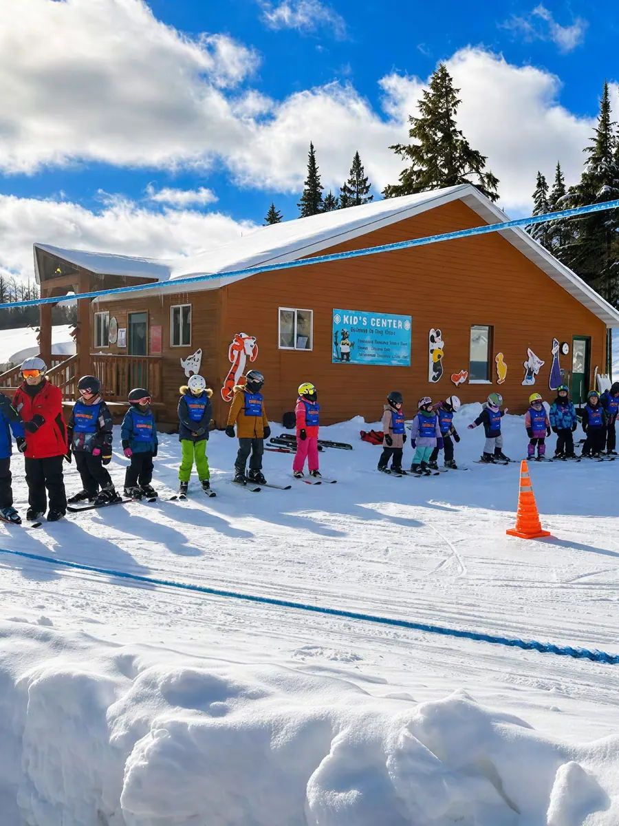 A group of young ski students lined up outside the Ski Brule kids center