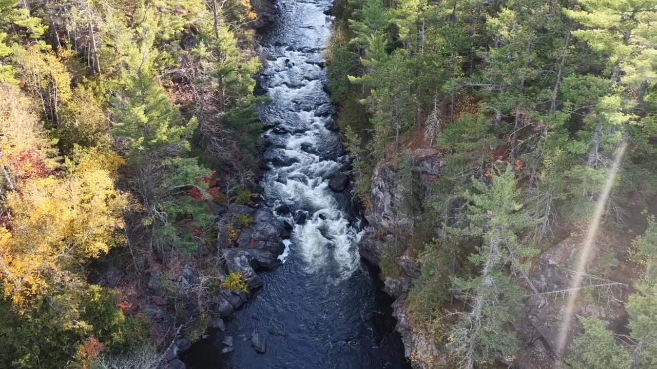The narrow Paint River gorge at Horserace Rapids seen from above, lined with fall color